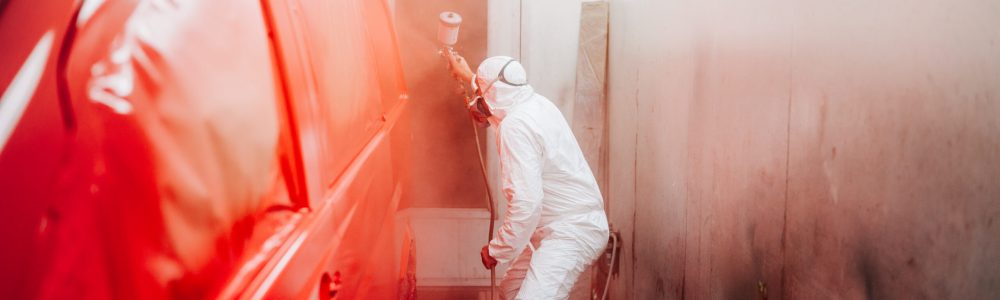 automotive industry manufacturing – mechanic engineer using spray gun and painting a red car automotive industry manufacturing - mechanic engineer using spray gun and painting a red car