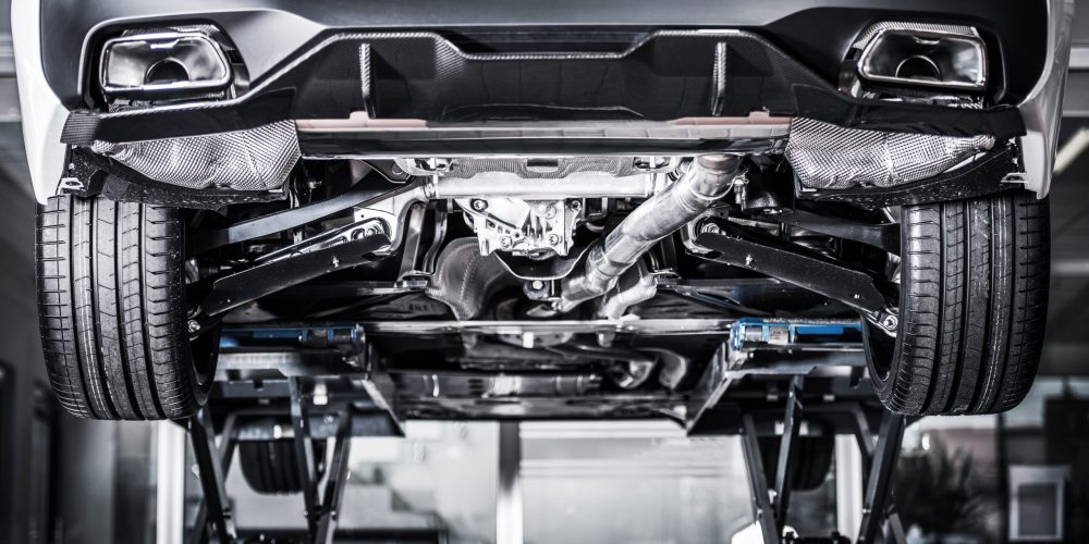 Car on a Vehicle Lift Inside the Auto Service Center. Panoramic Photo. Transportation Industry.